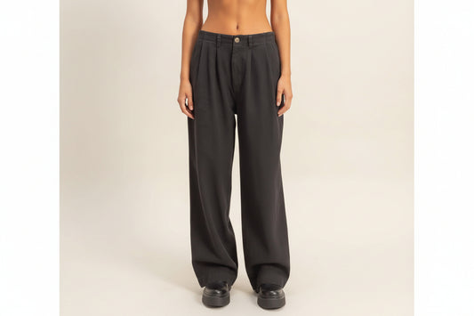 Dark gray pants worn by a person on a plain background