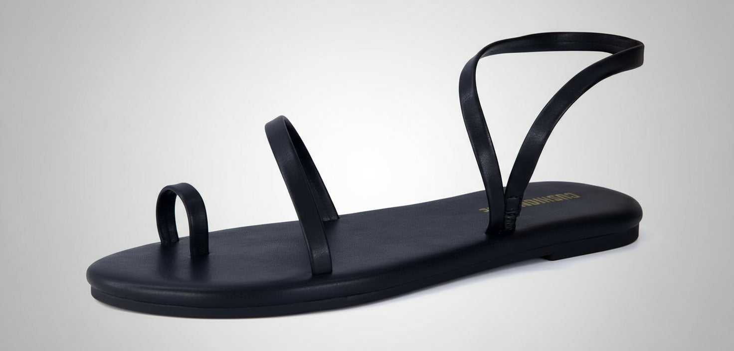 Black sandal with thin straps on a white background
